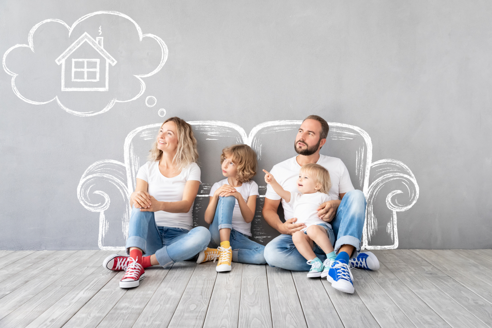 Happy family with two kids playing into new home