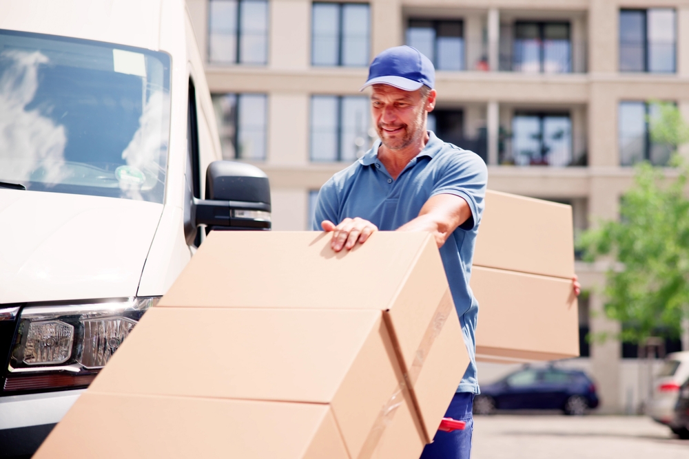 Delivery Man With Handtruck. Courier Near Car Truck