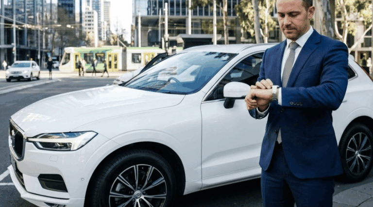 A pristine, white mid-size corporate SUV parked perfectly on a smooth, sealed asphalt surface in a modern Australian city business district.
